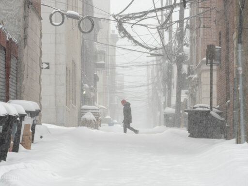 A man walks along 1st Street past historic Court Street
