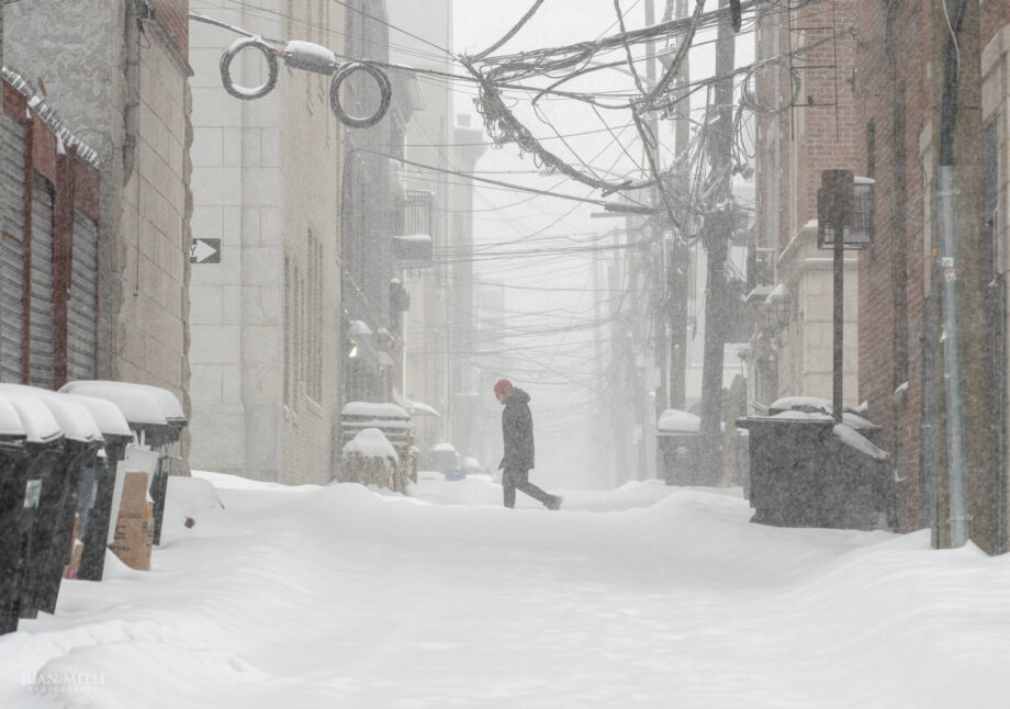 A man walks along 1st Street past historic Court Street