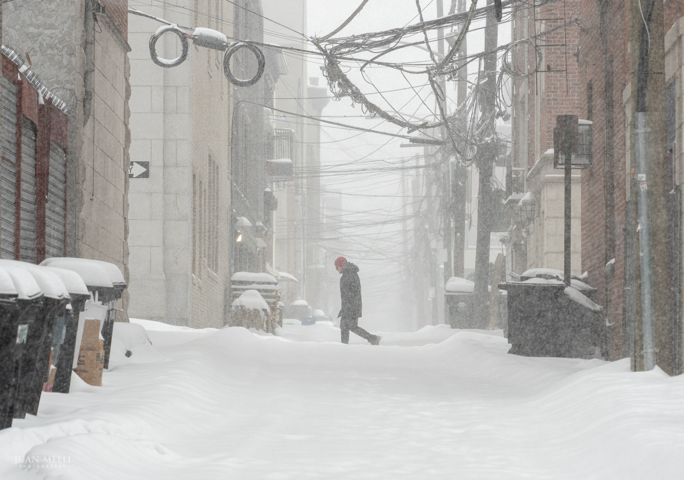 A man walks along 1st Street past historic Court Street