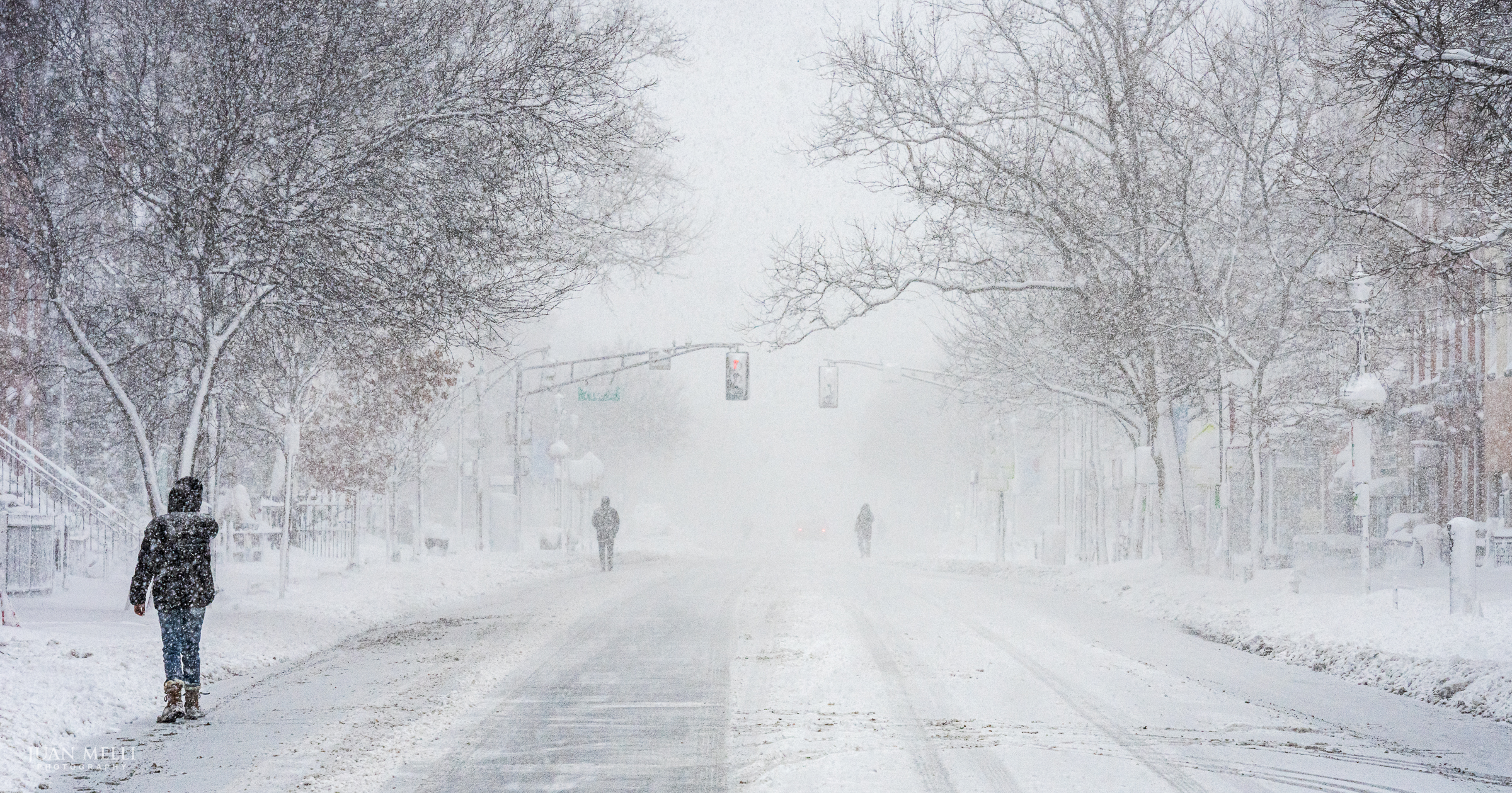 Pedestrians walk down Washington Street - easier than trudging through foot-deep snow on the sidewalk.