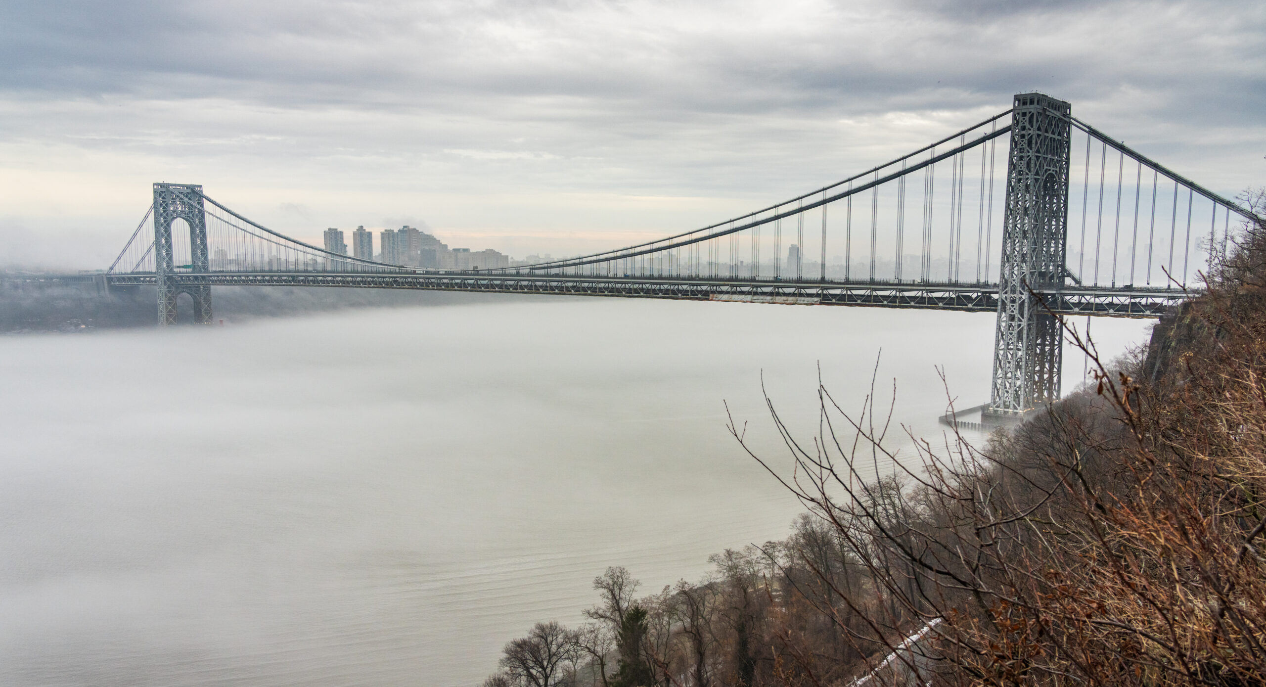 View from the Long Path of the George Washington Bridge over a fog-shrouded Hudson River