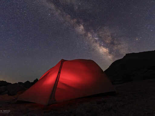 Milky Way and streaks from the Perseid meteor shower over camp