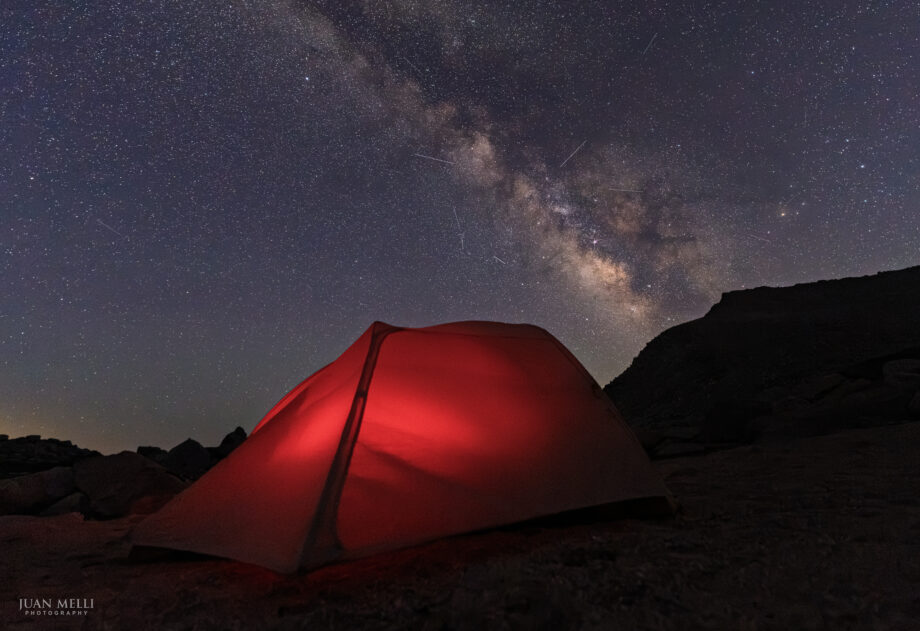Milky Way and streaks from the Perseid meteor shower over camp