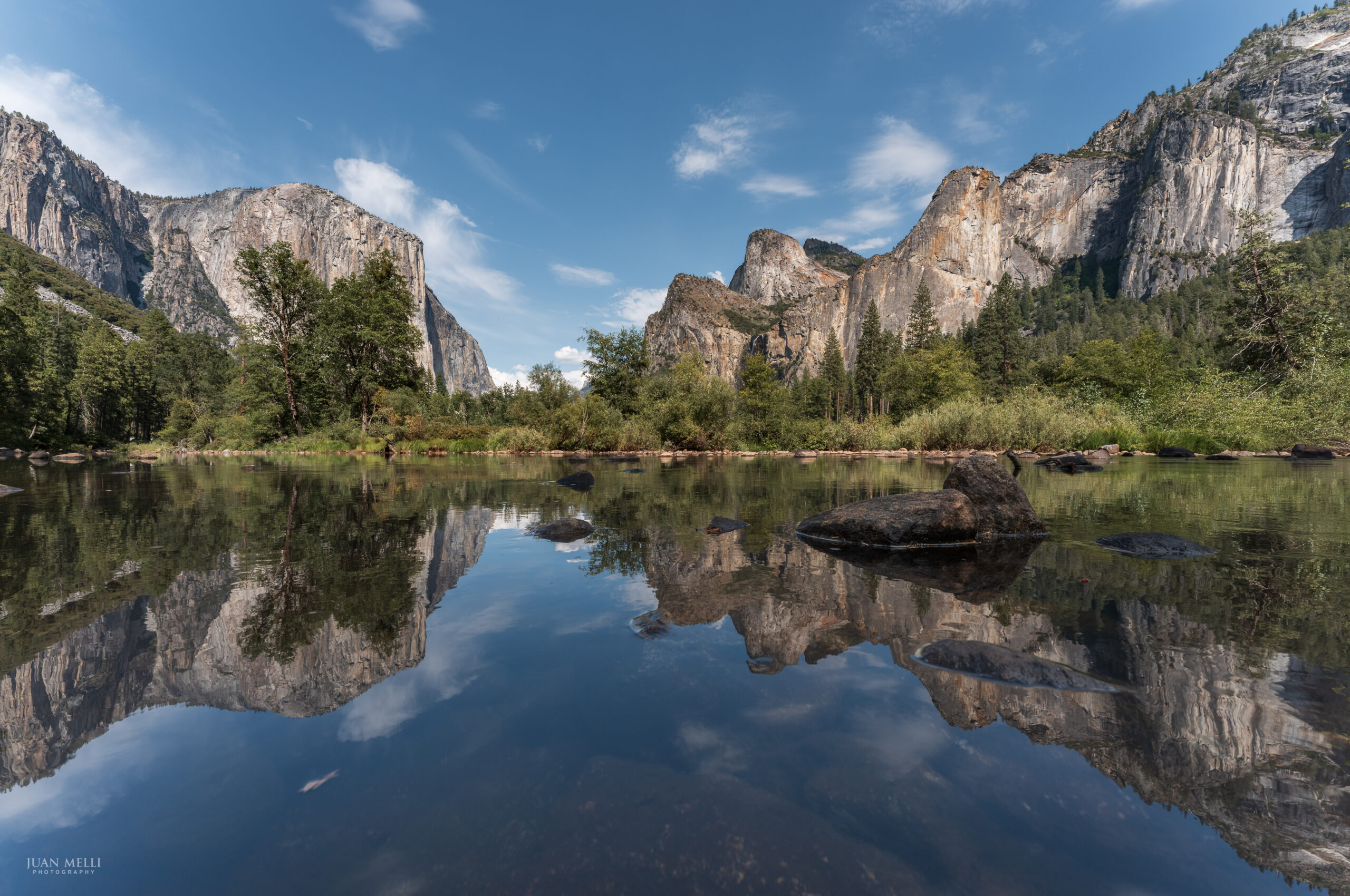 Gates of the Valley (aka Valley View) in Yosemite Valley, with El Capitan on the left and Cathedral Rocks on the right reflected in the calm Merced River.
